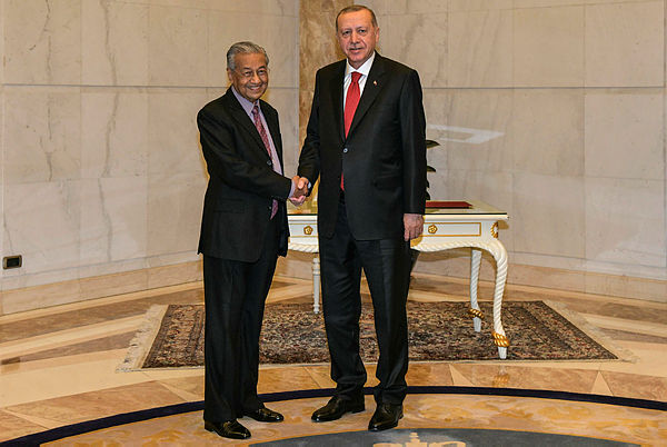 This handout photo from Malaysia’s Department of Information taken and released on December 18, 2019 shows Malaysia’s Prime Minister Mahathir Mohamad (L) and Turkey’s President Recep Tayyip Erdogan posing for photos ahead of their meeting in Putrajaya — AFP