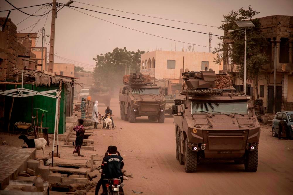Griffon armoured vehicles from Operation Barkhane patrol the streets before the handover ceremony of the Barkhane military base to the Malian army in Timbuktu, on December 14, 2021. - AFPPIX