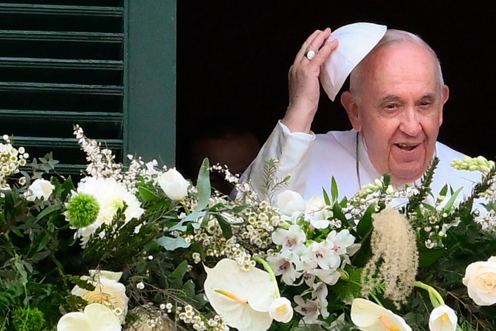Pope Francis holds his skullcap as he arrives on the balcony of the presidential palace on April 02, 2022 in Valletta, Malta. AFPPIX