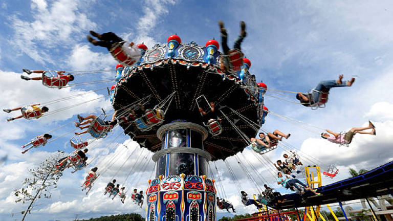Filepix showing visitors taking part in the ‘HyperSpin’ ride during the opening of the Movie Animation Park Studios, in Ipoh on June 26, 2017 — Bernama