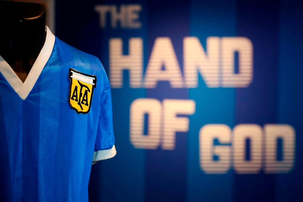 In this file photo taken on April 20, 2022 a football shirt worn by Argentina’s Diego Maradona during the 1986 World Cup quarter-final match against England, is pictured during a photocall at Sotheby’s auction house in London ahead of its sale. AFPpix