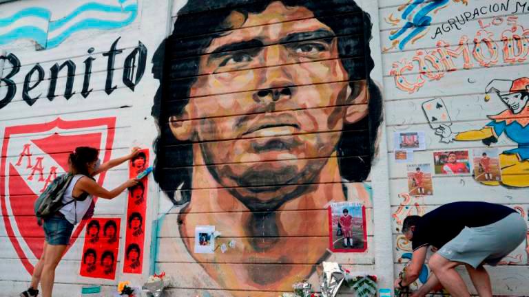 People gather to mourn the death of football legend Diego Maradona, outside the Diego Amrando Maradona stadium, in Buenos Aires November 25, 2020. — Reuters