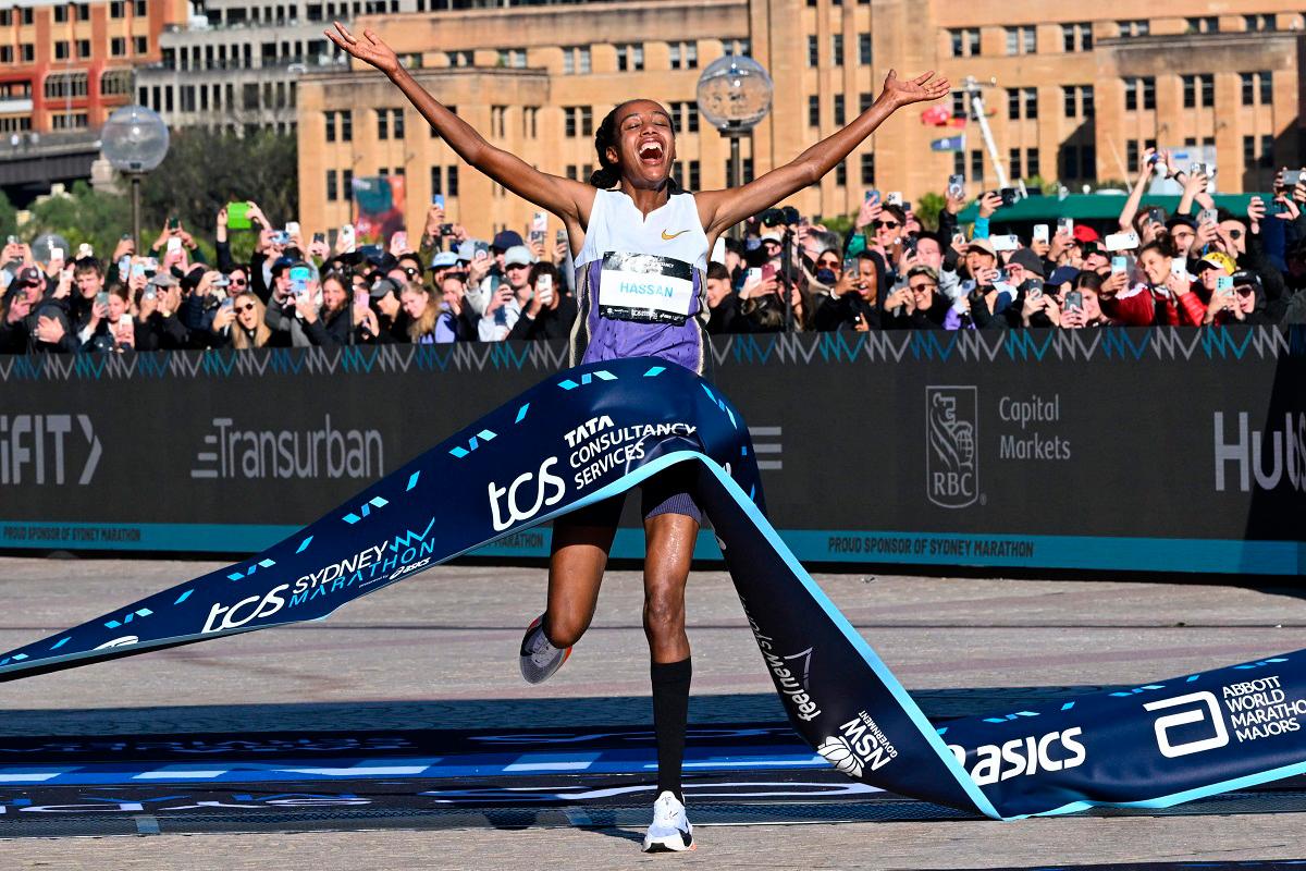 Netherlands’s Sifan Hassan crosses the finish line first in the 2025 Sydney Marathon, crossing the iconic Harbour Bridge on August 31, 2025. - Saeed KHAN / AFP