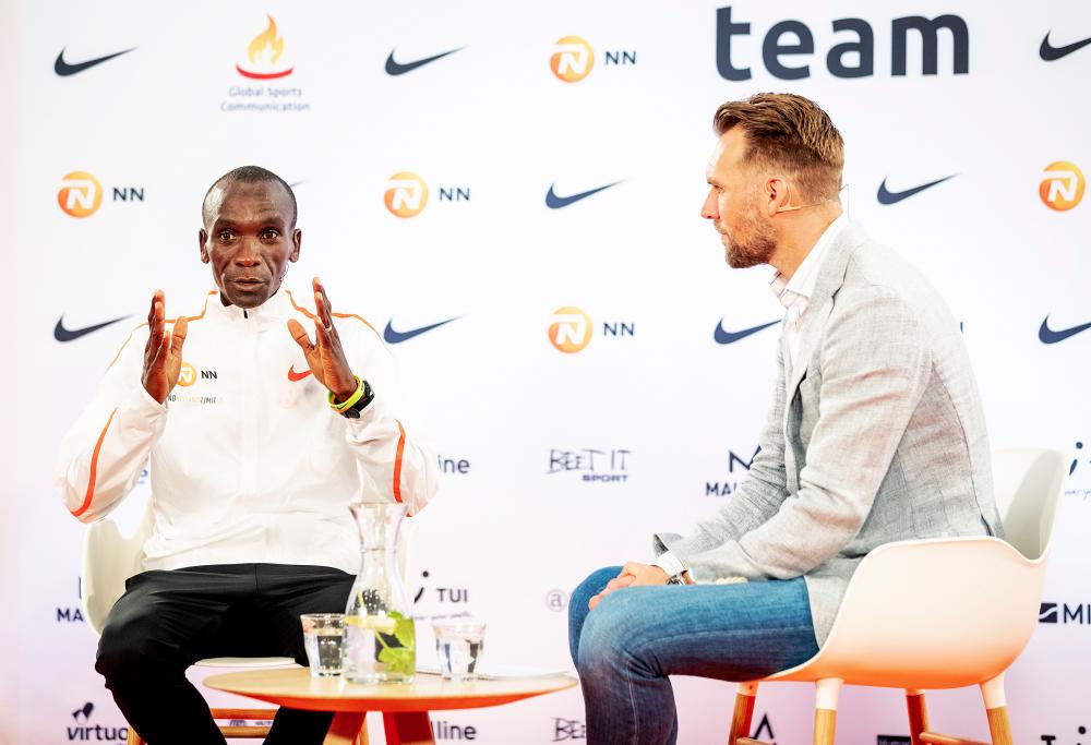 Kenyan athlete Eliud Kipchoge (L) speaks to the press in The Hague, on Oct 15, 2019. — AFP