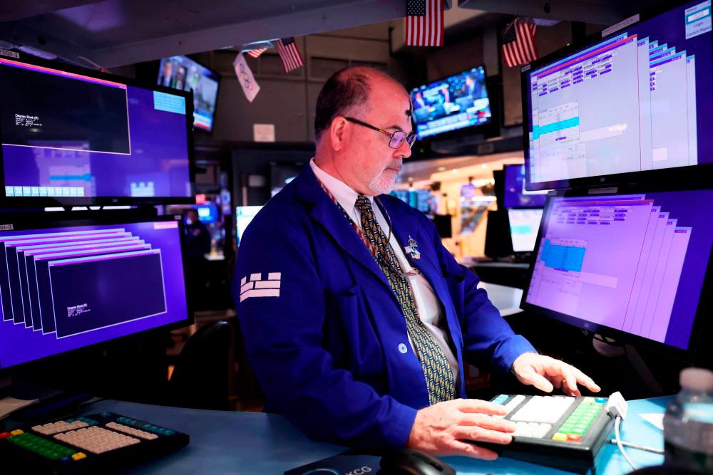 A trader working on the floor of the New York Stock Exchange./REUTERSPIC