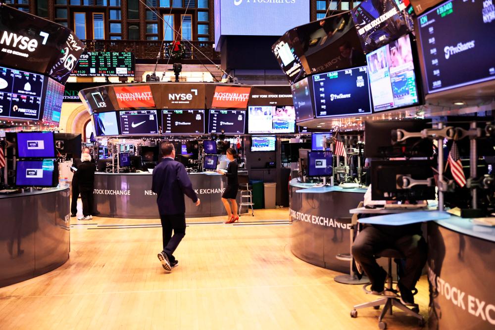 Traders working on the floor of the New York Stock Exchange during afternoon trading on Wednesday. – AFPpic