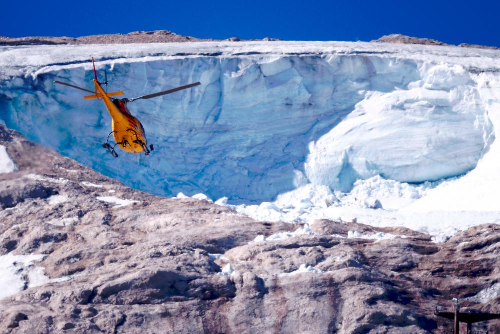 File photo: A helicopter participates in a search and rescue operation over the site of a deadly collapse of parts of a mountain glacier in the Italian Alps amid record temperatures, at Marmolada ridge, Italy July 6, 2022. REUTERSpix