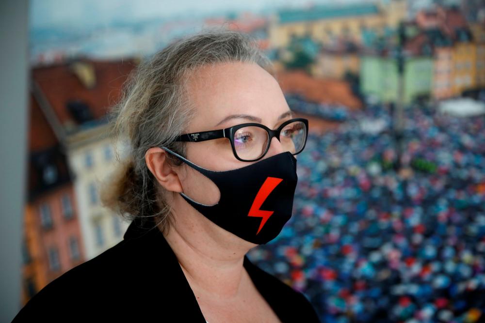Marta Lampert, leader of the movement Strajk Kobiet (Women's Strike), looks on while wearing a face mask during an interview with Reuters, in Warsaw, Poland, October 30, 2020. — Reuters