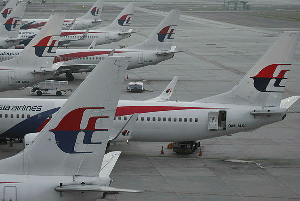 In this picture taken on March 8, 2015 Malaysia Airlines planes are seen at departure gates at Kuala Lumpur International Airport (KLIA) in Sepang. — AFP