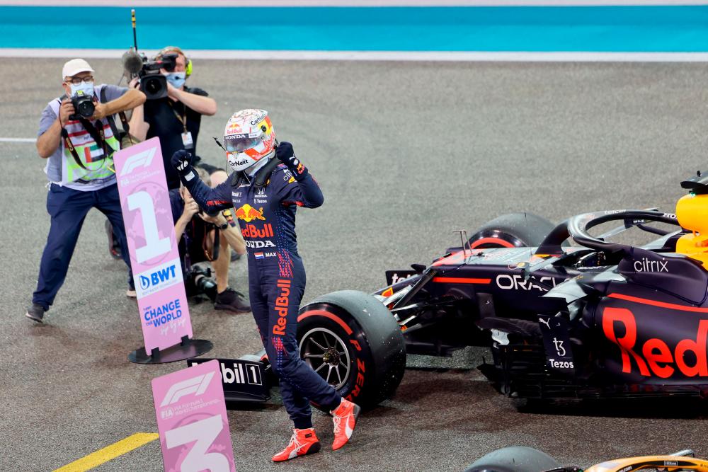 Red Bull's Dutch driver Max Verstappen celebrates in the Parc Ferme of the Yas Marina Circuit after he took the pole position during the qualifying session of the Abu Dhabi Formula One Grand Prix on December 11, 2021. AFPpix