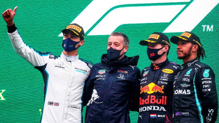 First-placed Red Bull’s Max Verstappen (2nd right), second-placed Williams’ George Russell (left) and third-placed Mercedes’ Lewis Hamilton (right) pose on the podium after the F1 Belgian GP at the Spa-Francorchamps circuit. – AFPPIX