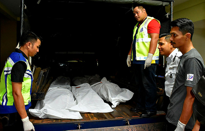 Rescue officers in the midst of transporting the remains of six of the victims to the Alor Gajah Hospital, on Aug 9, 2019. — Bernama