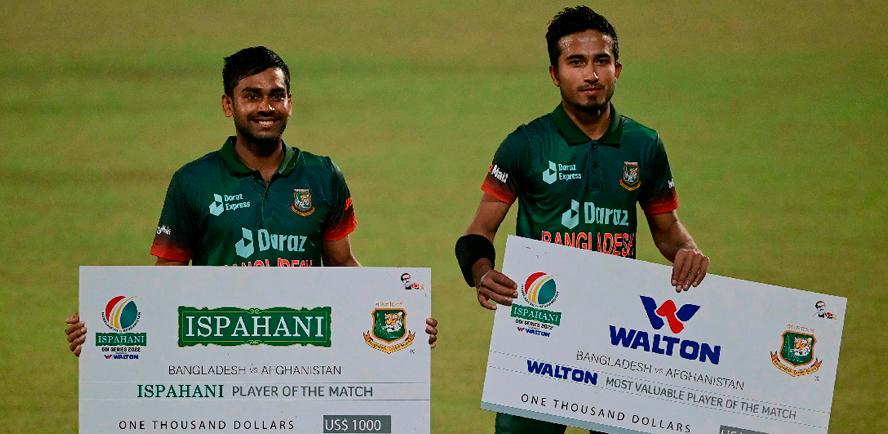 Bangladesh’s Mehidy Hasan Miraz (left) with his teammate Afif Hossain pose for a picture with their respective recognitions after their win in the first one-day international (ODI) cricket match against Afghanistan at the Zahur Ahmed Chowdhury Stadium in Chittagong. – AFPPIX