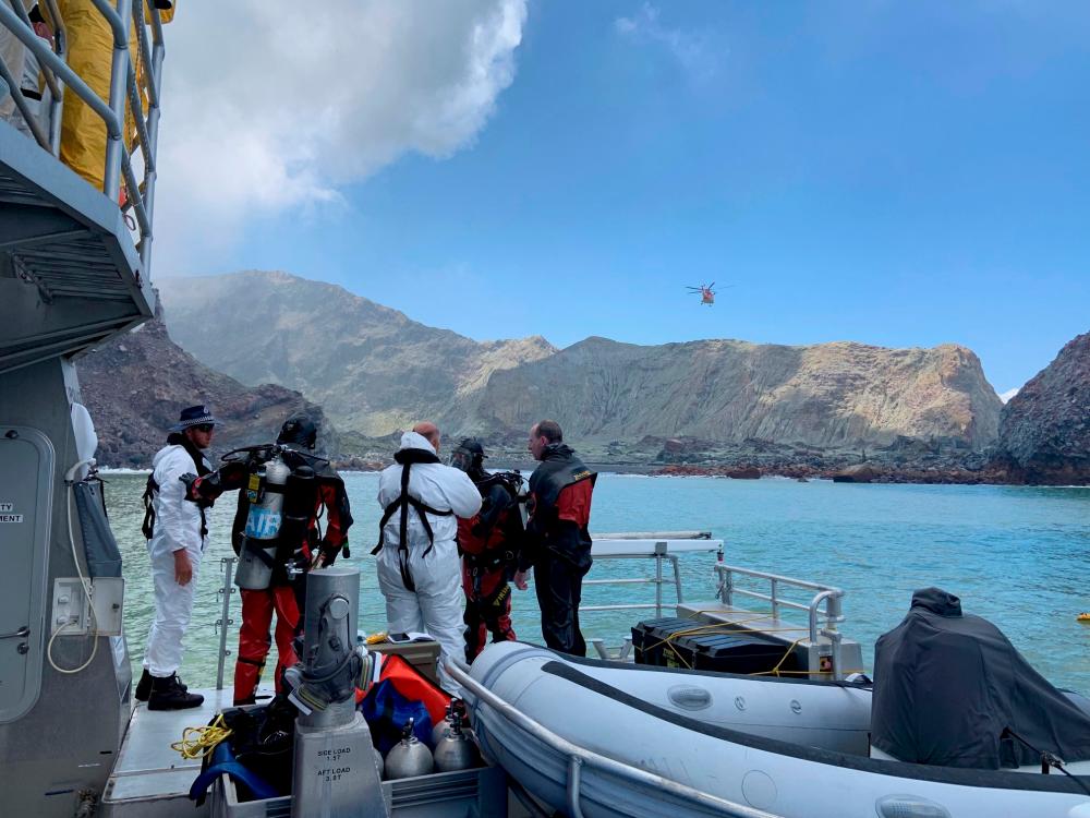 Members of a dive squad conduct a search during a recovery operation around White Island, which is also known by its Maori name of Whakaari, a volcanic island that fatally erupted earlier this week, in New Zealand, December 13, 2019 in this handout photo supplied by the New Zealand Police. - Reuters