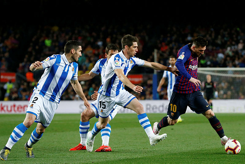 Barcelona’s Lionel Messi (R) vies with Real Sociedad’s Spanish Aritz Elustondo (2R) during their La Liga match at the Camp Nou, on April 20, 2019. — AFP
