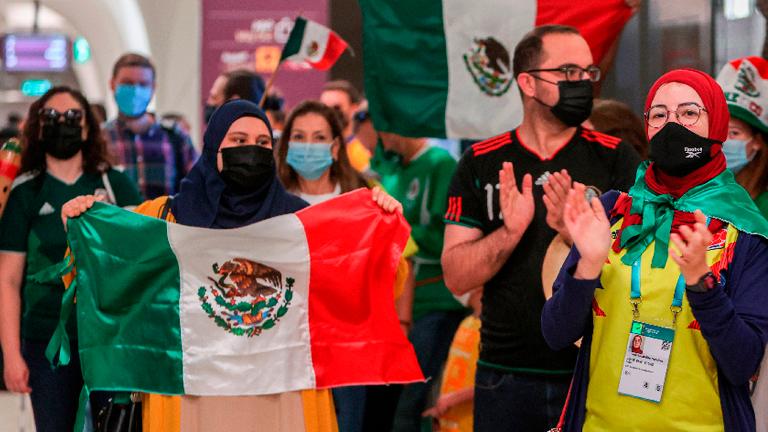 Supporters of Mexico’s Tigres UANL football club cheer with a Mexican national flag as they walk at a station of the Doha Metro while on the way to attend a club fan event outside Education City Stadium in the Qatari city of Ar-Rayyan on Jan 30, 2021, ahead of their match against Ulsan Hyundai FC the following week. – AFPPIX