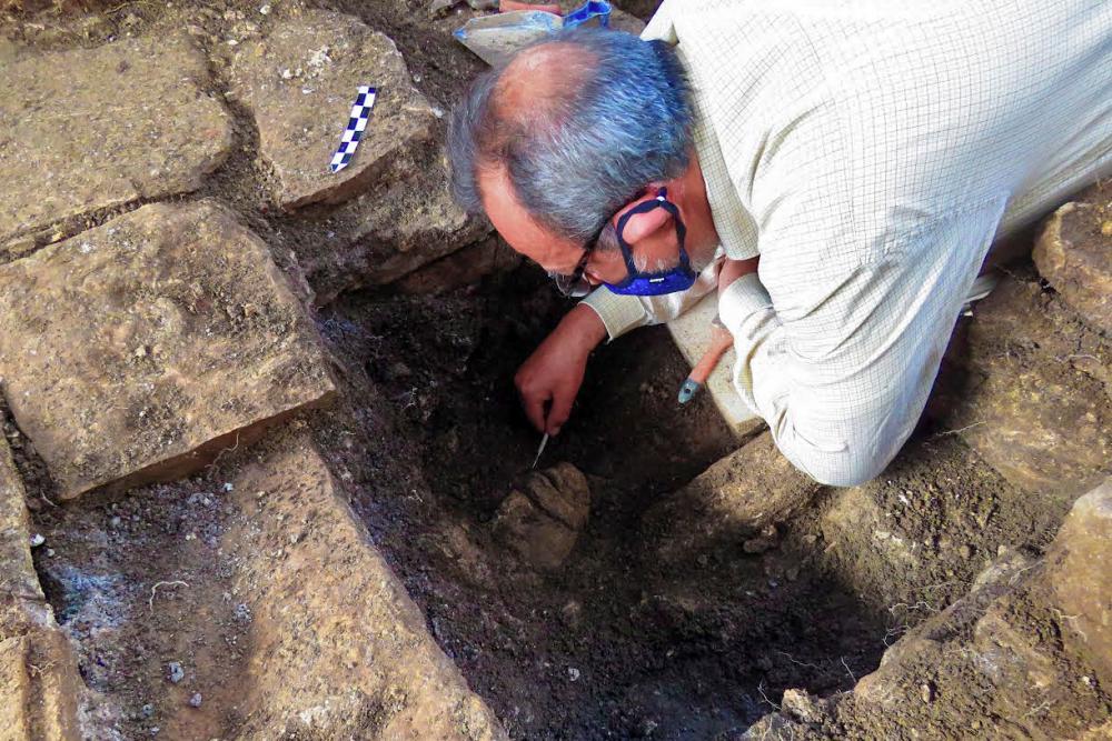 Undated aerial handout picture realeased by the National Institute of History and Anthropology (INAH) showing an archaeologist working on a representation of the Young Maize God at the Archaeological Complex of Palenque, Chiapas state, Mexico. AFFPIX