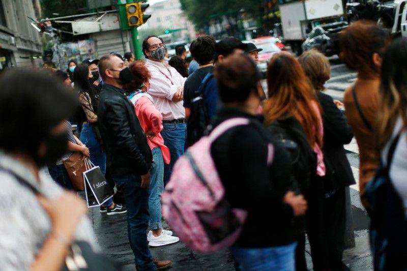 People wearing face masks wait at a traffic junction as Mexico City’s authorities announce a full reopening of the city come Monday, the first time since the coronavirus disease (Covid-19) pandemic, Mexico June 4, 2021. — Reuters