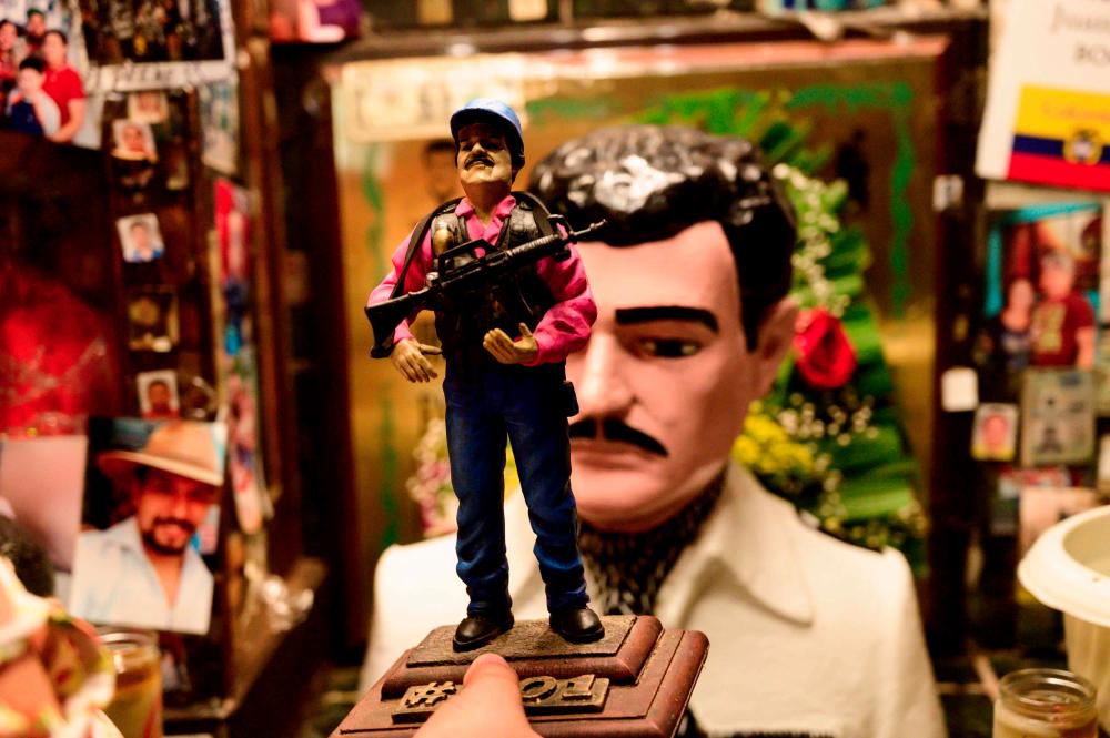 A statue of Mexican drug lord Joaquin “El Chapo” Guzman, is displayed for sale near a bust of narco-saint Jesus Malverde, at his chapel in Culiacan, Sinaloa state in northwest Mexico, on July 16, 2019. — AFP