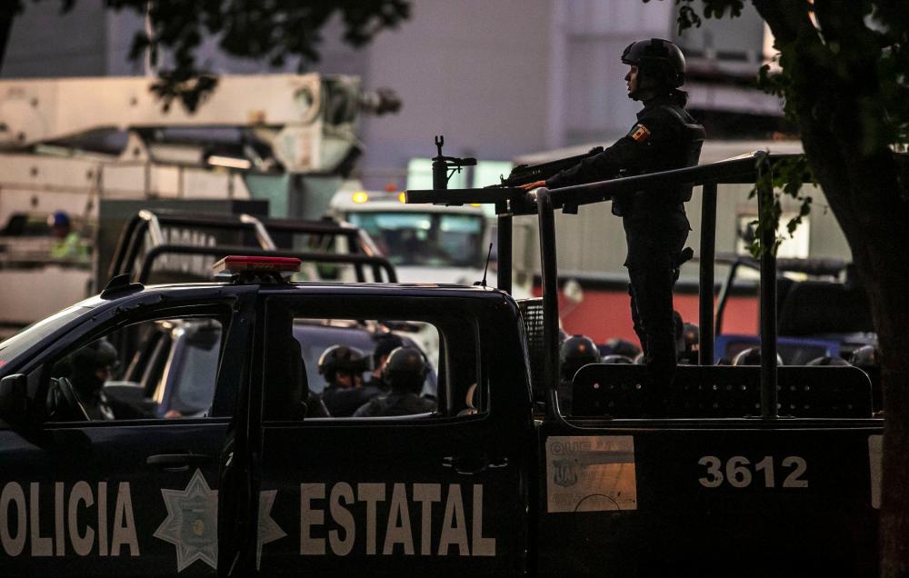 Mexican police patrol in a street of Culiacan, state of Sinaloa, Mexico, on Oct 17, 2019, after heavily armed gunmen in four-by-four trucks fought an intense battle with Mexican security forces. — AFP