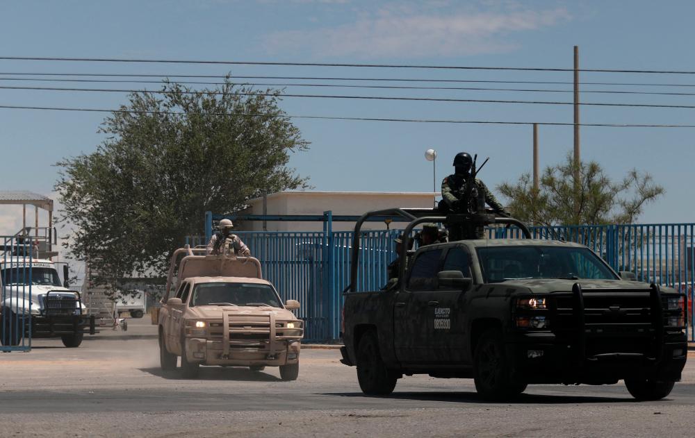 Members of the National Guard and the Mexican Army leave the airport after landing in Ciudad Juarez, state of Chihuahua, Mexico, on August 12, 2022, after a rash of violence in the city. AFPPIX