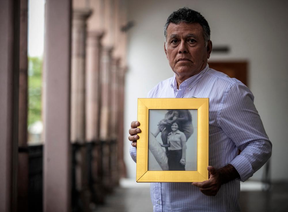 Roberto Martinez poses holding the portrait of his sister Lourdes, who disappeared in 1974, in Culiacan, state of Sinaloa, Mexico on October 18, 2021. AFPpix