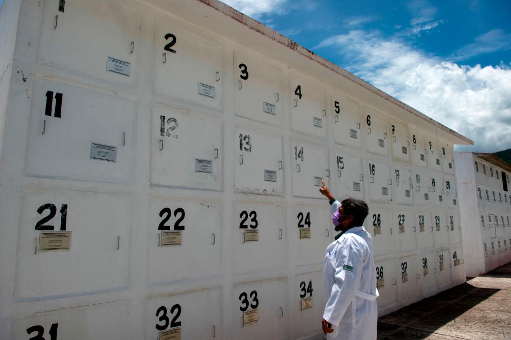 Alfonso Ramírez, Medical Coordinator of the Chilpancingo Forensic Medical Service shows graves at the Forensic State Cemetery in Chilpancingo, Guerrero State, on September 6, 2022. AFPPIX