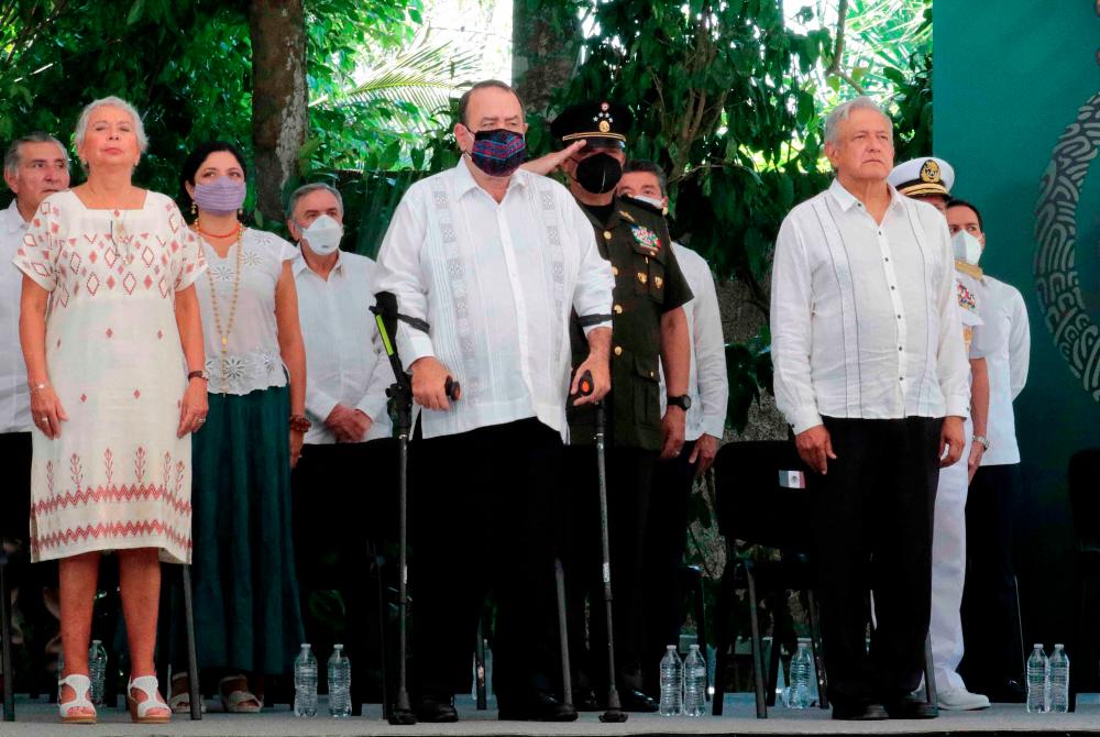 Handout picture released by the Mexican Presidency showing Mexican President Andres Manuel Lopez Obrador (R), his Guatemalan counterpart Alejandro Giammattei (C) and his Interior Secretary Olga Sanchez Cordero (L) during the Appeal for Forgiveness for Grievances to the Mayan People ceremony, in Felipe Carrillo Puerto, Quintana Roo State, Mexico, on May 3, 2021. -AFP PHOTO / MEXICO’S PRESIDENCY