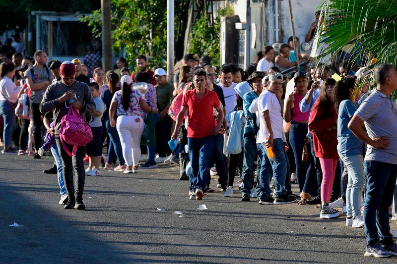 Migrants wait outside the regional office of the National Migration Institute to await their safe conduct to transit through Mexican territory on their way to the United States, in Tapachula, Chiapas state, Mexico on January 13, 2025. AFPPix