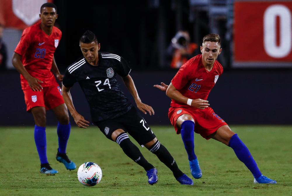 Roberto Alvarado #24 of Mexico drives by Tyler Boyd #21 of the United States during their match at MetLife Stadium on Sept 6, 2019 in East Rutherford, New Jersey. - AFP
