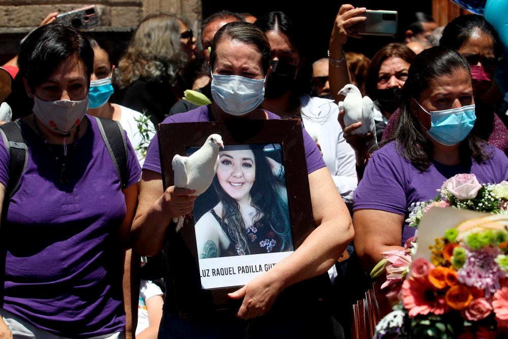 People and relatives of activist Luz Raquel Padilla, who was set on fire by strangers, take part in a demonstration to demand justice during his wake in Zapopan, Mexico/AFPPix