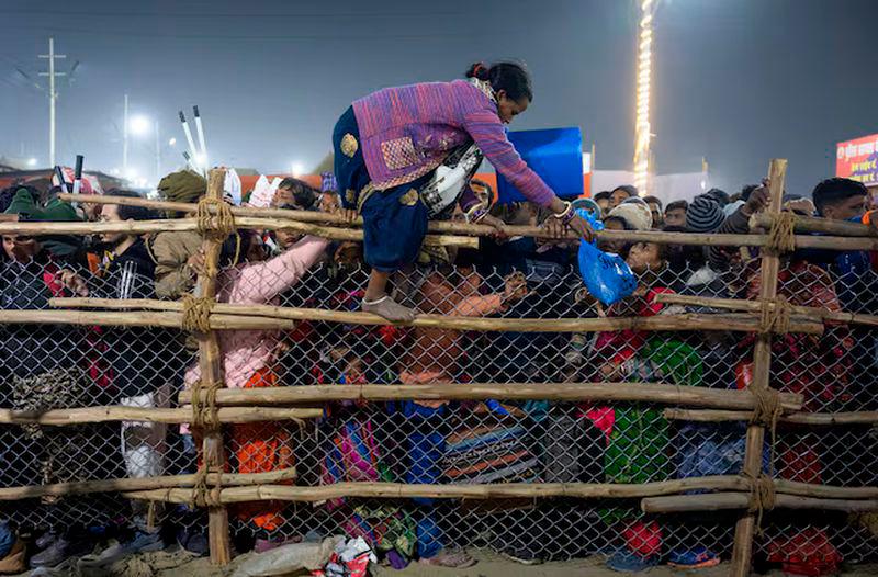 A devotee crosses over a barricade, after a deadly stampede before the second “Shahi Snan” (royal bath), at the “Maha Kumbh Mela” or the Great Pitcher Festival in Prayagraj - REUTERSpix