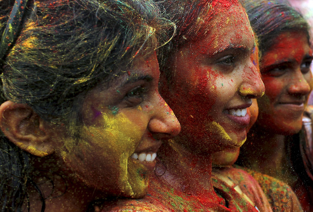 Participants of the Holi festival have their faces splattered with different colours at the Shree Lakshimi Narayan Temple. — Sunpix by Asyraf Rasid