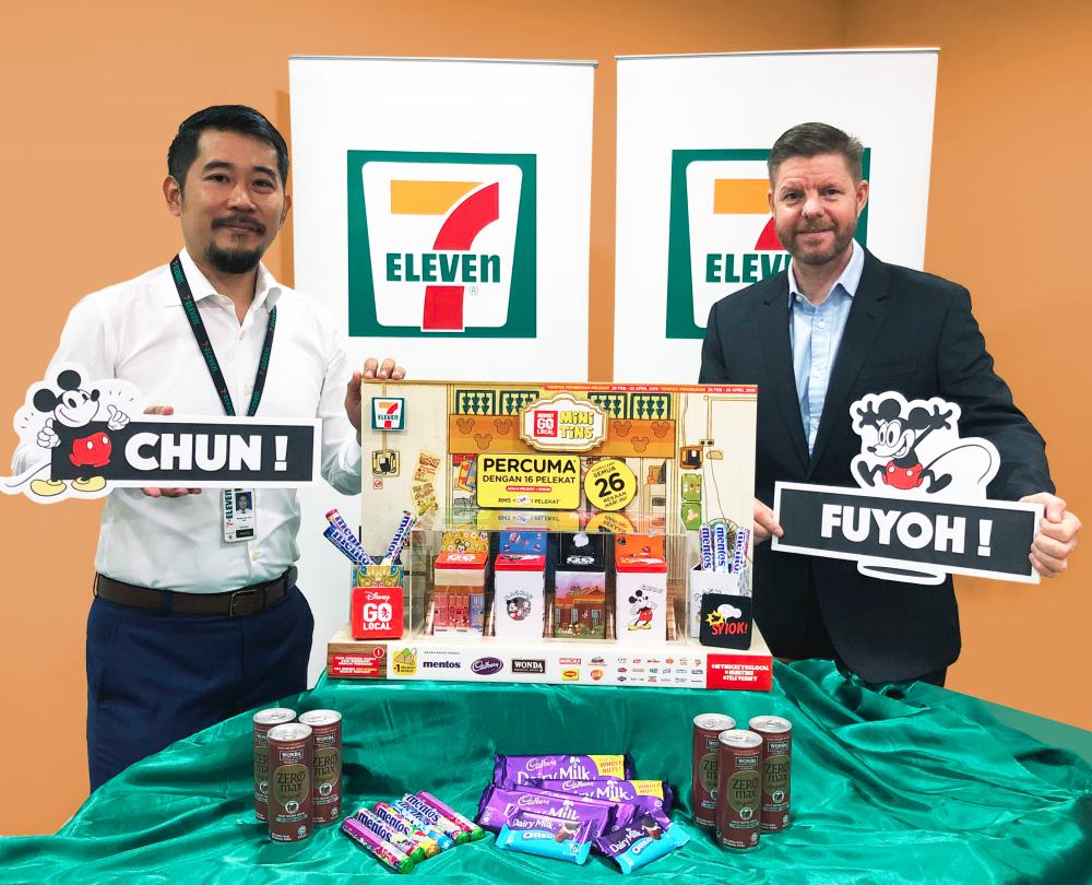 Lee (left) and 7-Eleven Malaysia’s CEO Colin Harvey with the Mickey Go Local Mini Tins collection.