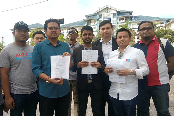 The PKR Youth secretary Ahmad Syukri Che Ab Razab (second, left) showing the police reports during a press conference at Bukit Beruang yesterday. — Bernama