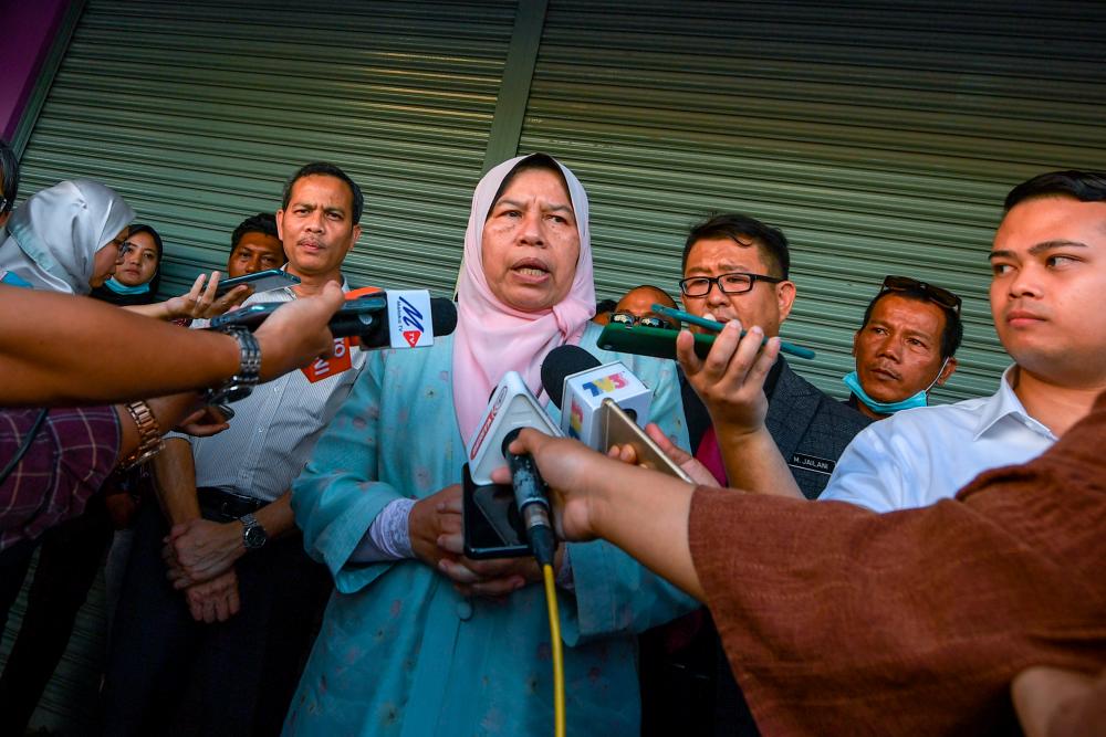 The Housing and Local Government Minister Zuraida Kamaruddin (C) talked to reporters after the opening of Hang Tuah Jaya parliamentary People’s Service Centre (PKN) yesterday. — Bernama