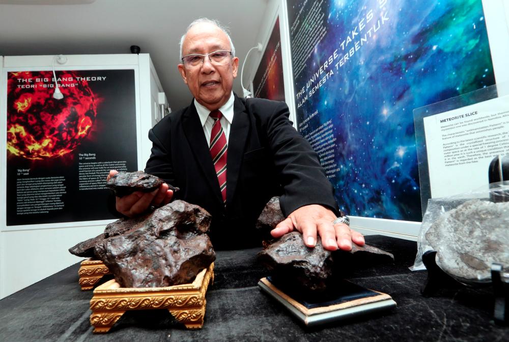 Meteor Gallery owner, Datuk Jaafar Jamaludin showing pieces of meteorites exhibited in his gallery at Muzium Rakyat in Bandar Hilir, on Sept 22, 2019. — Bernama