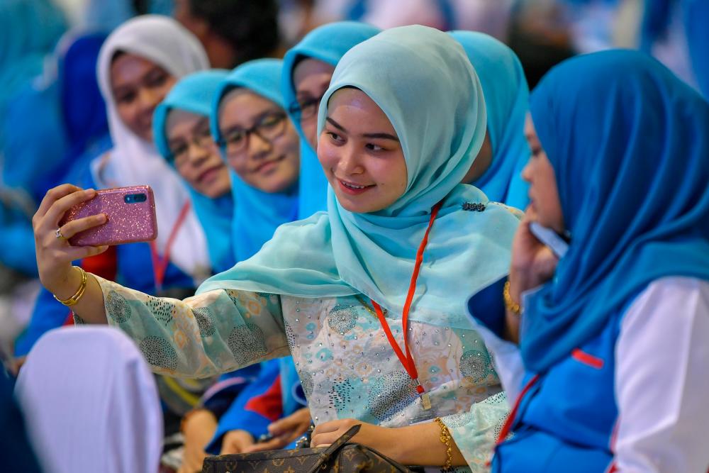 PKR Wanita delegates take selfies, during its congress at the Malacca International Trade Centre (MITC) in Ayer Keroh, on Dec 6, 2019. — Bernama