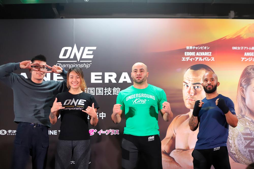 Angela “Unstoppable” Lee (2nd L), “The Underground King” Alvarez (2nd R) and Demetrious “Mighty Mouse” Johnson (R) pose for a photo.