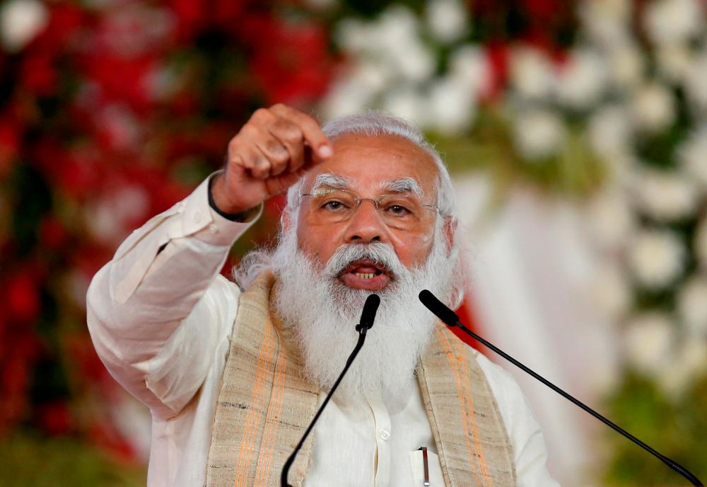 FILE PHOTO: India's Prime Minister Narendra Modi addresses a gathering before flagging off the Dandi March, or Salt March, to celebrate the 75th anniversary of India's Independence, in Ahmedabad, India, March 12, 2021. REUTERSpix