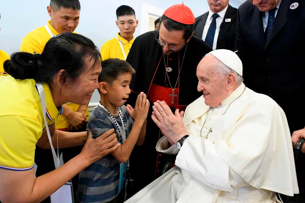 A Child welcomes Pope Francis for a meeting with charity workers and for the inauguration of the House of Mercy in Ulaanbaatar on September 4, 2023. AFPPIX