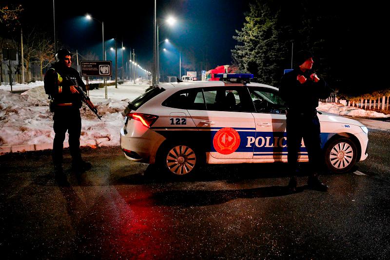 Police officers stand guard at a check point on the outskirts of Cetinje, on January 1, 2025, after a gunman killed several people in the nearby village of Bajice. A gunman killed several people on January 1, 2025 in a village restaurant in southern Montenegro, near the town of Cetinje, the prime minister said, confirming a police statement reported by state broadcaster RTCG. “A terrible tragedy has struck all of us in Cetinje, in the village of Bajice near Cetinje” Milojko Spajic told RTCG. - SAVO PRELEVIC / AFP