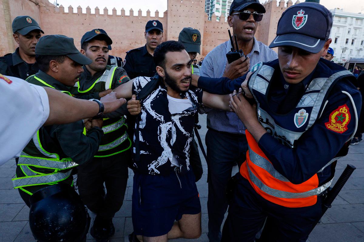 Members of the security forces detain a protester during a youth-led demonstration in Rabat on September 29, 2025, calling for reforms in the public health and education sectors. - Majid BZIOUAT / AFP