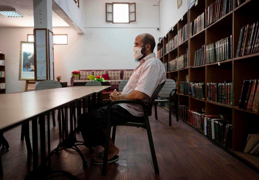 Saleh, a prisoner who has been languishing in Moroccan jails for 19 years on terrorism charges, sits at the library inside the prison of Kenitra, in the coastal city of the same name, near the Moroccan capital Rabat, on August 31, 2021. AFPPix