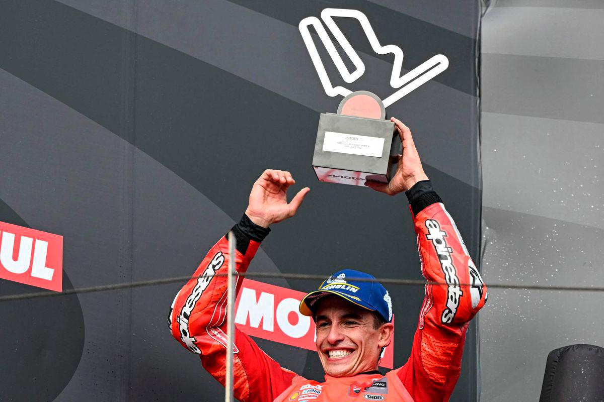 Ducati Lenovo Team’s Spanish MotoGP rider Marc Marquez celebrates on the podium with his trophy after the MotoGP class race of the MotoGP Japanese Grand Prix at the Mobility Resort Motegi in Motegi, Tochigi prefecture on September 28, 2025. (Photo by Toshifumi KITAMURA / AFP)