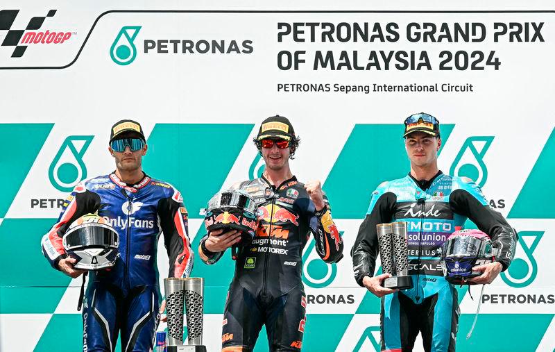 Red Bull KTM Ajo’s Italian rider Celestino Vietti (C), OnlyFans American Racing Team’s Jorge Navarro (L) and CFMOTO Aspar Team’s Spanish rider Izan Guevara (R) pose on the podium after the Moto2 race of the MotoGP Malaysian Grand Prix at the Sepang International Circuit in Sepang - AFP