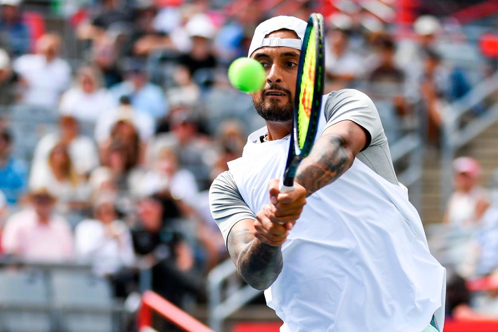 MONTREAL, QUEBEC - AUGUST 10: Nick Kyrgios of Australia hits a return against Daniil Medveded during Day 5 of the National Bank Open at Stade IGA on August 10, 2022 in Montreal, Canada. AFPPIX