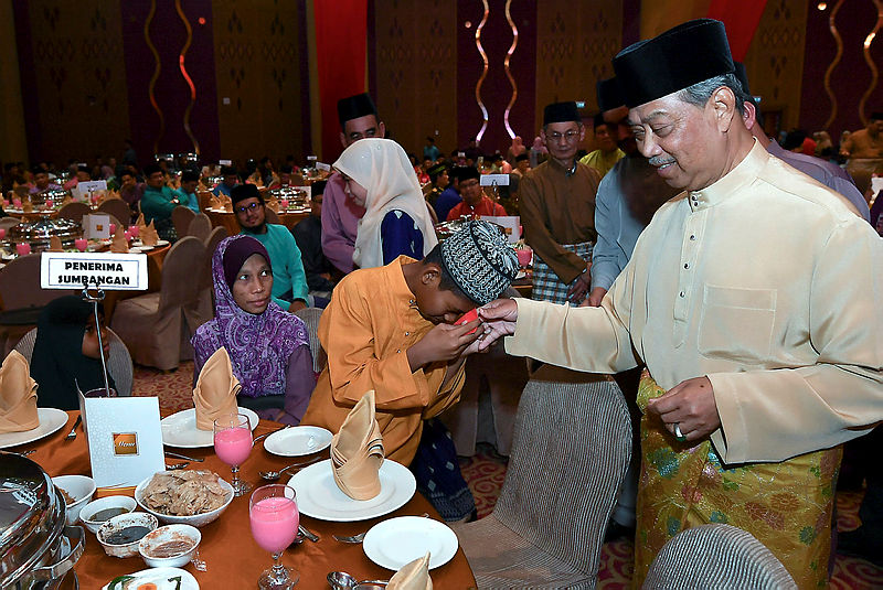 Home Minister Tan Sri Muhyiddin Yassin greets guests at the ministry’s breaking fast event last night.