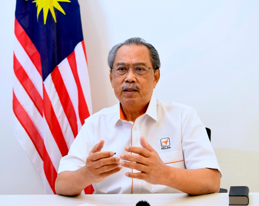 Prime Minister Tan Sri Muhyiddin Yassin delivering a speech at the opening of the Felda Settlers' Day 2021 celebration at the national level which was broadcast online today. — Bernama