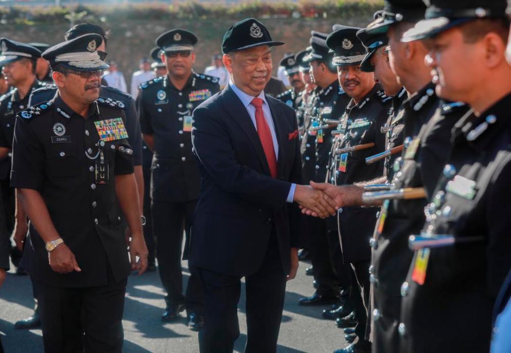 Home Minister Tan Sri Muhyiddin Yassin is greeted by officers from the General Operations Forces (PGA), on Feb 12, 2019. — Sunpix by Amirul Syafiq Mohd Din